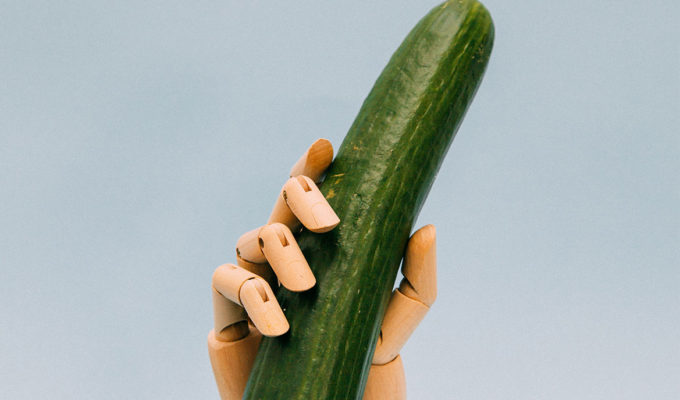 Robot hand holding a cucumber